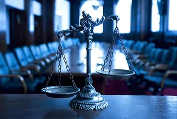 The scales of justice, a conference table, and chairs, symbolizes the Judicial Conference.